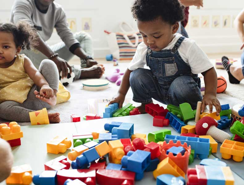 Young children playing and creating art together